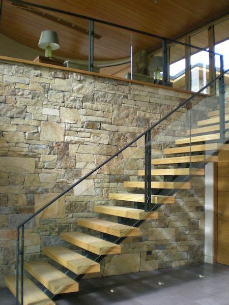 Wood Stair Glass And Metal Railing And Stone Wall West