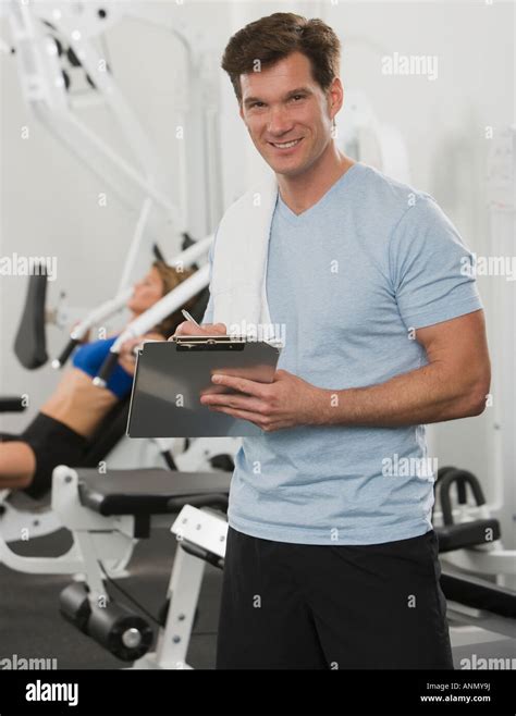 Male Personal Trainer Writing On Chart Stock Photo Alamy
