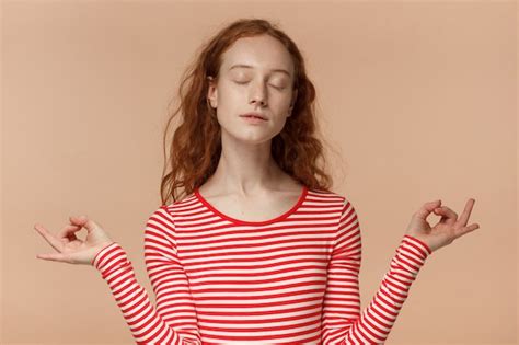 Premium Photo Redhead Female Meditating With Arms Spread Showing Mudra