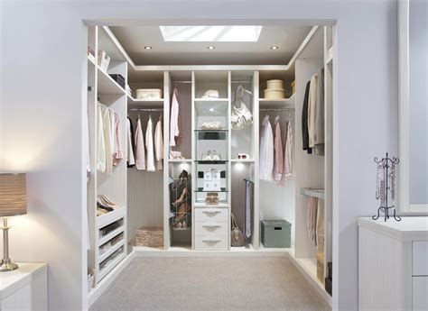 A Walk In Closet With White Walls And Drawers