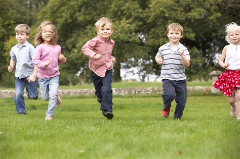 Small Group Young Children Running In Park Orlando Private School