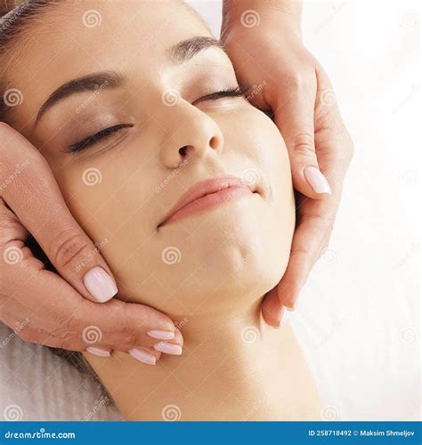 Beautiful Young And Healthy Woman Having Face Massage In Spa Salon Hands Of Professinal