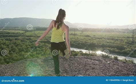 The Sport Girl Performs Yoga Exercises In The Outdoor Backside View