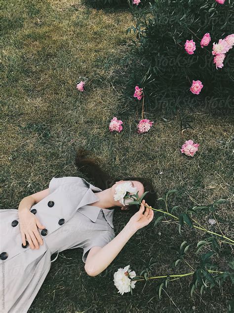 Woman Hiding Her Face Behind Flower By Stocksy Contributor Amor