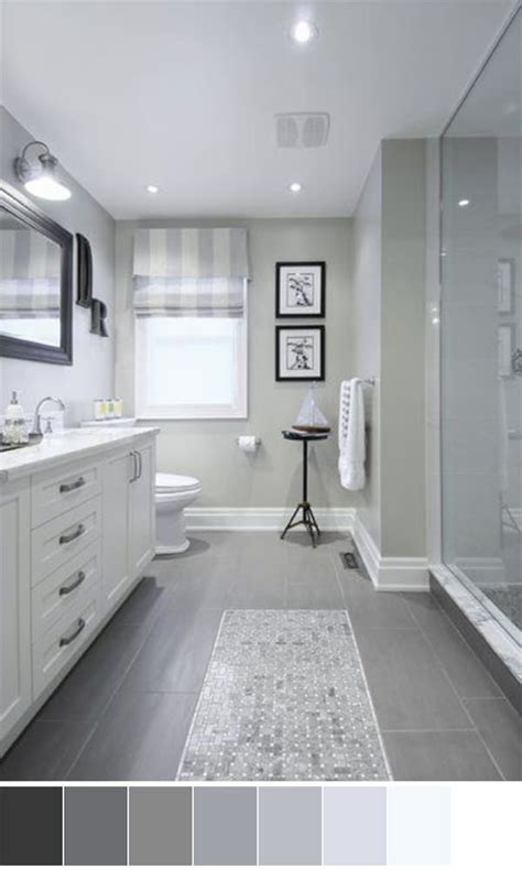 A Large Bathroom With Gray Tile Flooring And White Walls Along With A