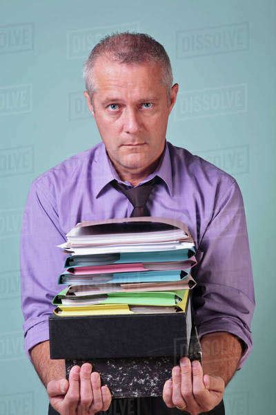 Man Holding A Stack Of Paper Work Stock Photo Dissolve