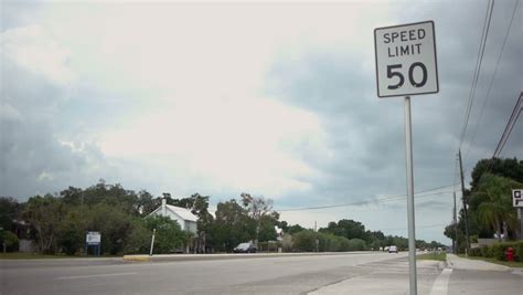 50 Mph Speed Limit Sign By Road In Florida A Jeep Drives By Fast
