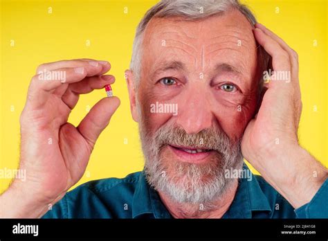 Happy Old Man Holding Vitamins Studio Yellow Background Stock Photo Alamy