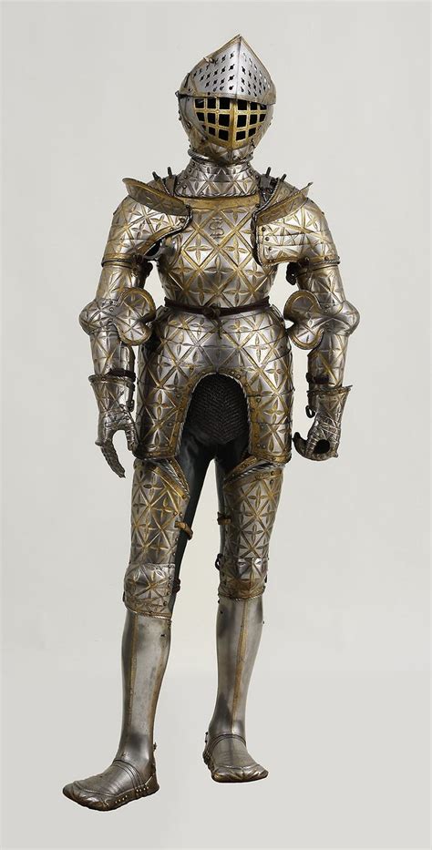 The Armor Is Made From Metal And Has Intricate Designs On Its Chest