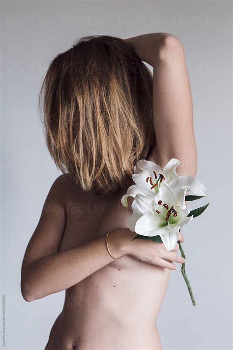 Nude Woman With Lily By Stocksy Contributor Lucas Ottone Stocksy