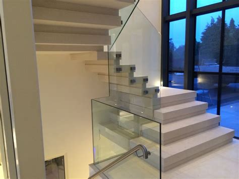 Contemporary Solid Stone Staircase With Frameless Glass Balustrade