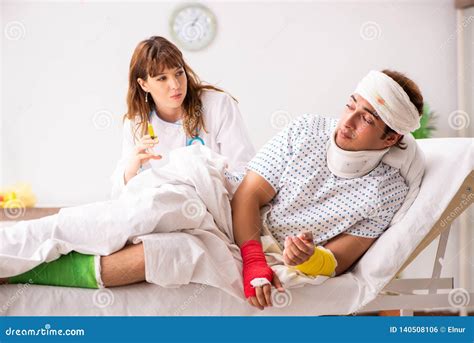 The Young Doctor Examining Injured Patient Stock Photo Image Of