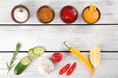 Composition With Different Sauces On White Wooden Background Top View