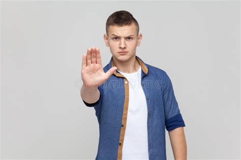 Teenager Boy Making Stop Gesture Showing Palm Of Hand Conflict