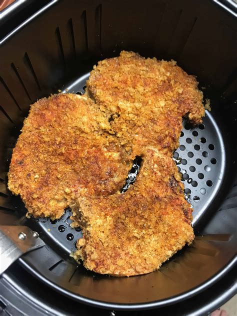 Looking for new ways to spice up basic pork chops? Crispy Keto Parmesan Crusted Pork Chops in the Air Fryer - iSaveA2Z.com