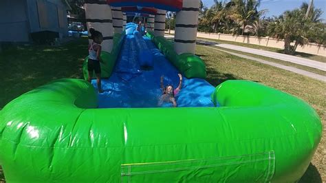 Dual Lane Tropical Inflatable Slip N Slide Playing On The Bounce House