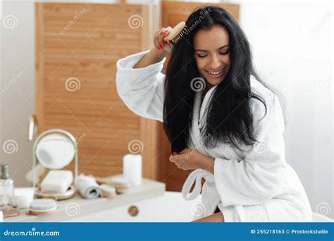 Female Brushing Long Hair With Hairbrush Sitting In Modern Bathroom Stock Image Image Of