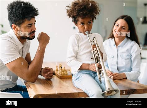 Proud Parents Watching Their Child Plays Trumpet Stock Photo Alamy