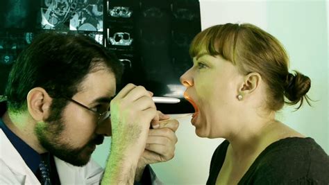 Doctor Checking Throat HD Routine Throat Checkup On A Woman With Irritated Tonsils Take
