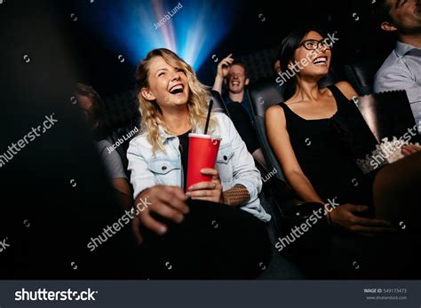 Young People Laughing While Watching Film Stock Photo 549173473