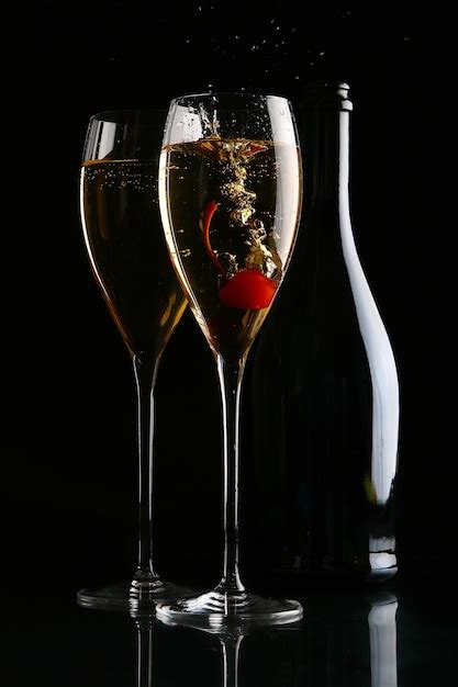 Free Photo Two Elegant Glasses With Champagne And Cherry