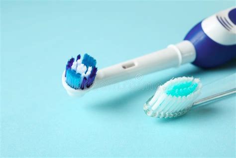 Manual And Electric Toothbrushes On Color Background Stock Image