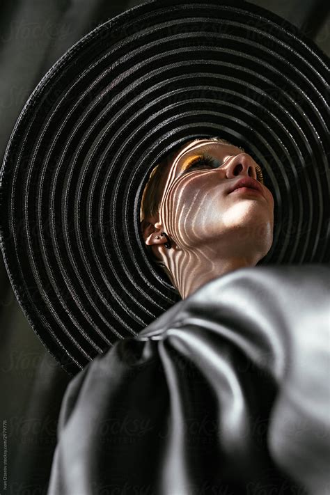Bottom View Of A Beautiful Model In A Wide Hat And Beautiful Shadows From The Hat On Her Face