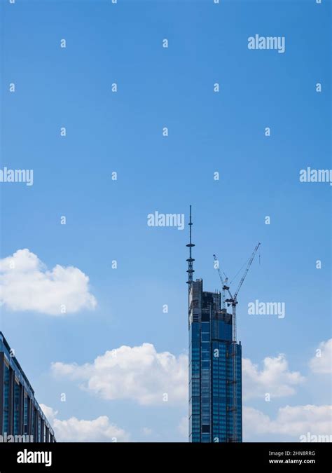 Building Of A Modern Skyscraper Front View Over Blue Sky Background