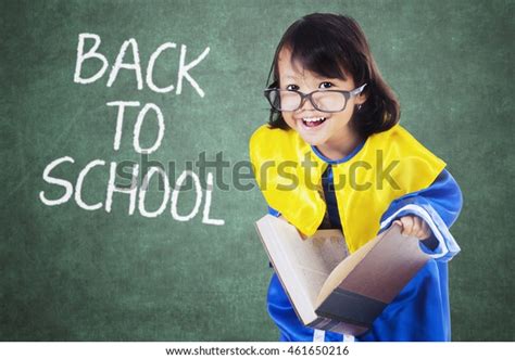 Female Primary School Student Holding Book Stock Photo 461650216
