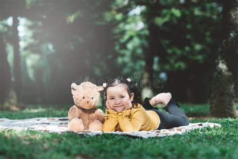 Little Asian Girl Lying Down Beside Her Teddy Bear Stock Image Image