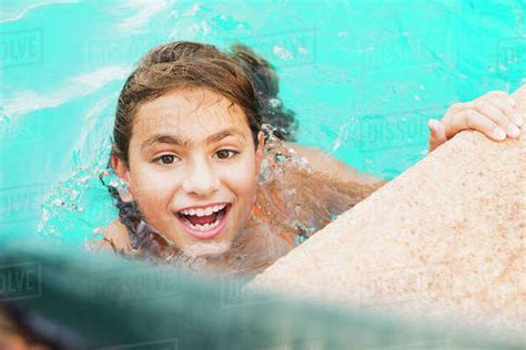 Mixed Race Girl Swimming In Pool Stock Photo Dissolve