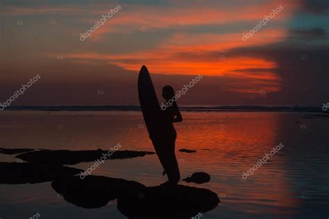 Silhouette Surfer Woman In Bikini On Tropical Beach Holding Surfboard At Sunset Stock Photo By