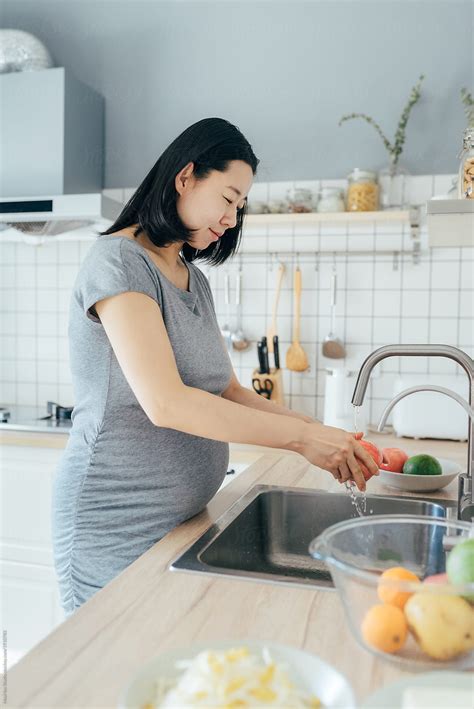 pregnant woman in the kitchen by stocksy contributor maahoo stocksy