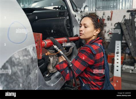 Woman Auto Mechanic Fixing Car In Automobile Garage Stock Photo Alamy