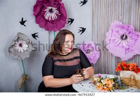 Sexy Chubby Woman Is Sitting With A Cup In His Hands