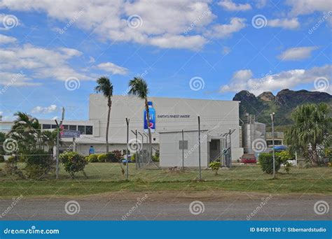 Tall Fence Surrounding Fiji Water Bottled Water Factory With Mountain