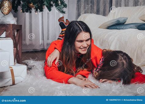 two girls sisters have relax and fun in a room decorated for christmas and the new year stock