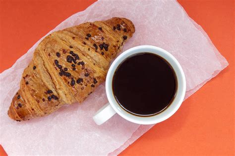 Black Coffee Without Milk In A White Cup And A Chocolate Croissant