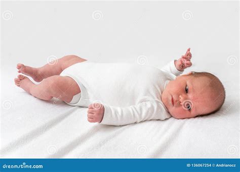 Newborn Baby Is Lying On Back On White Blanket Stock Photo Image Of