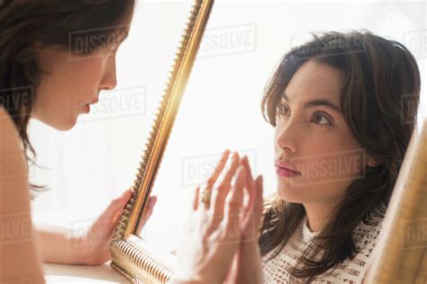 Serious Young Woman Looking Into Mirror Stock Photo Dissolve