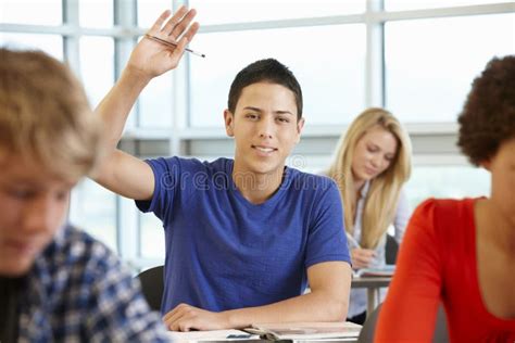 Hispanic Student Asking Question In Class Stock Photo Image Of