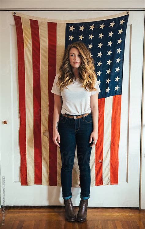 Young Woman Standing In Front Of American Flag By Trinette Reed Stocksy United