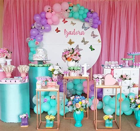 A Table Topped With Lots Of Cakes And Desserts Covered In Pink And Blue Flowers