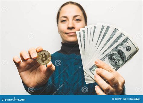 Young Smiling Woman Shows Golden Bitcoin Coin Symbol Of