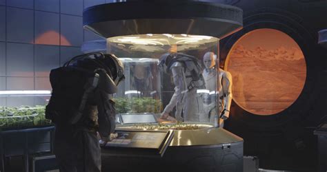 Medium Shot Of Astronauts And Humanoid Robot Examining Plant Incubators