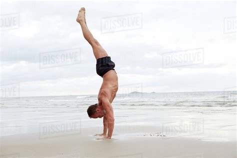 Man Doing Handstand On Beach Stock Photo Dissolve