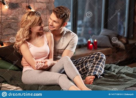 Couple Wearing Pajamas Enjoying Evening Together In