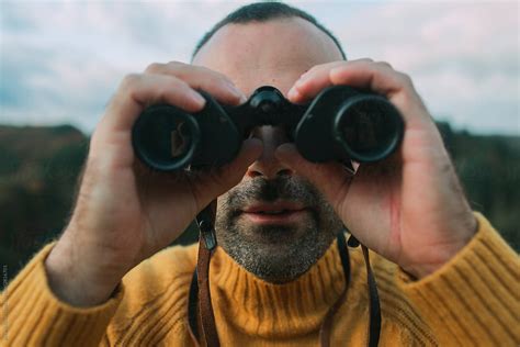 Man Looking Through Binoculars In Camera By Stocksy Contributor