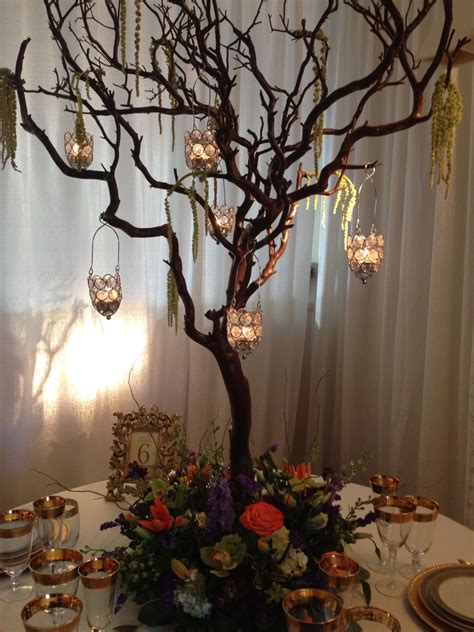 5 cool diy branch centerpieces for holidays. Single-branch manzanita centerpiece with crystal hanging votive holders and a wreath of fresh ...
