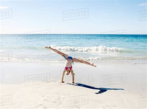 Girl Doing Handstand And Splits On Beach Stock Photo Dissolve
